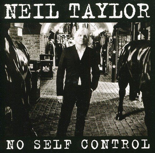 Black and white album cover with man standing between horse statues, wearing a dark suit.