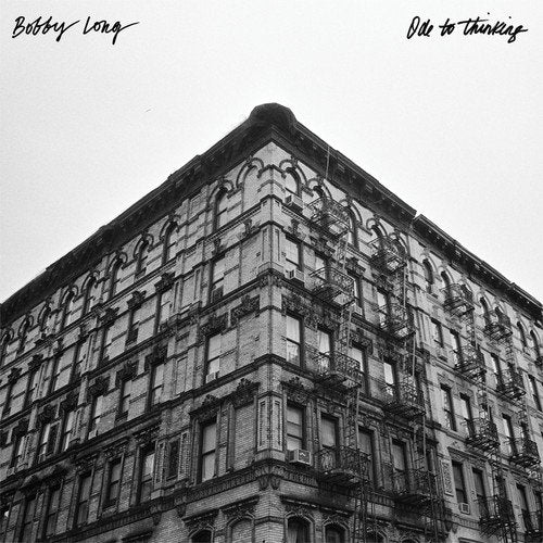 "Album cover featuring a black and white image of a large building."