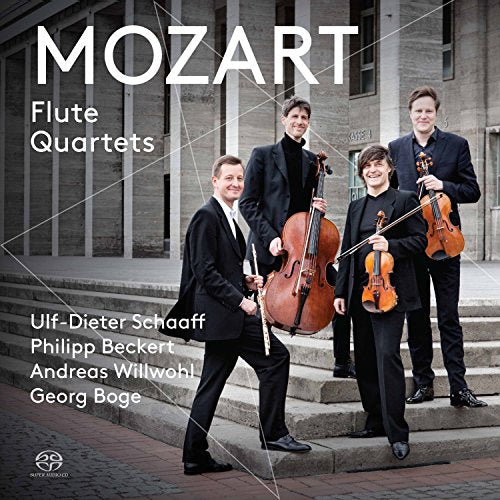 "CD cover featuring four musicians in black standing on stone steps with instruments."