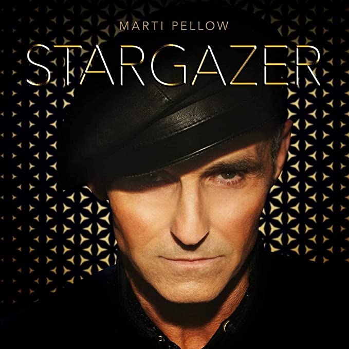 Marti Pellow's album cover: man in black hat and shirt, geometric gold pattern.