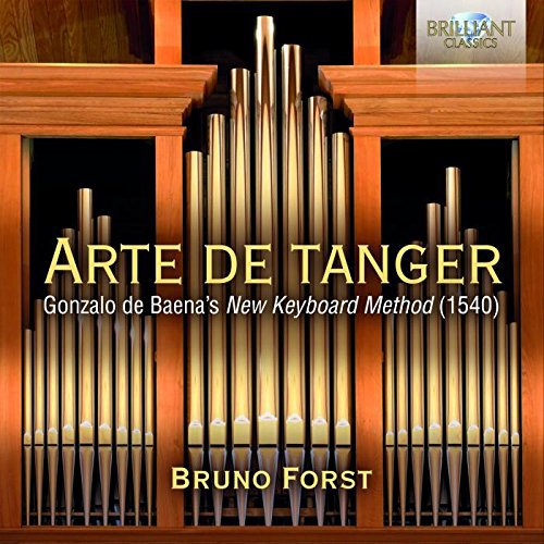 Organ pipes on a wooden cabinet with "Arte de Tanger" text overlay.