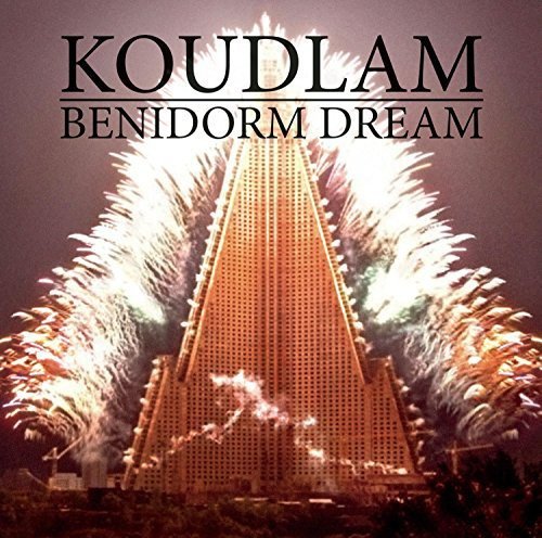 "Album cover for 'Benidorm Dream' by Koudlam, featuring a tall building with fireworks."