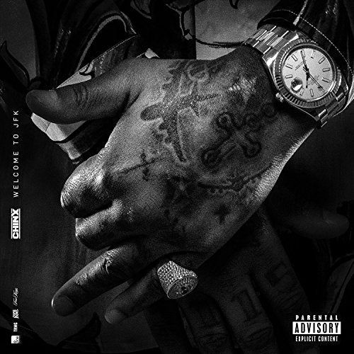 Black and white album cover featuring a hand with tattoos and a watch.