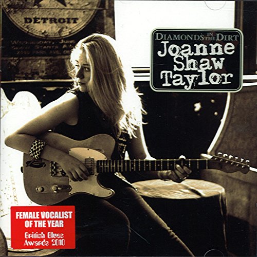 "Album cover featuring a blonde woman playing guitar, with award badge and title text."