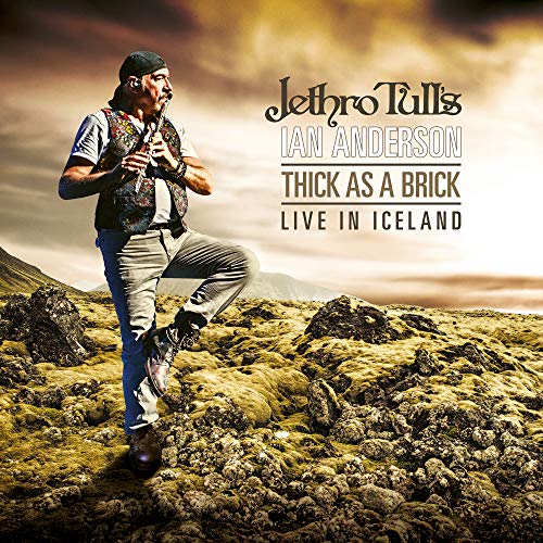 Ian Anderson standing on rocky terrain, holding flute, with text overlay on cloudy background.