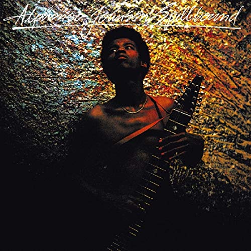 "Album cover featuring a man holding a guitar against a textured, multicolored background."