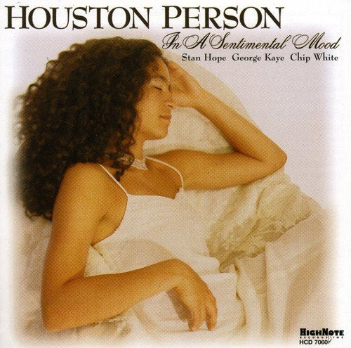 Album cover with a woman lying on a bed, wearing a white dress.
