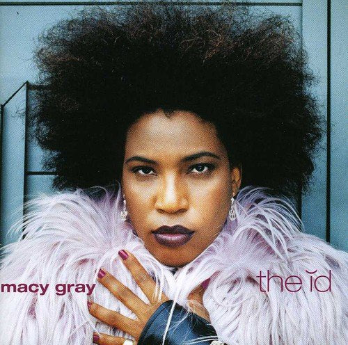 Macy Gray's album cover featuring a woman with an afro and feathered jacket.