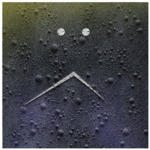 A vinyl record cover with a face-like design featuring bubbles and a triangular mouth.