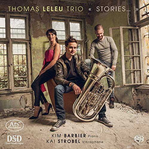 "Album cover featuring three musicians posing in a dilapidated room with a tuba."