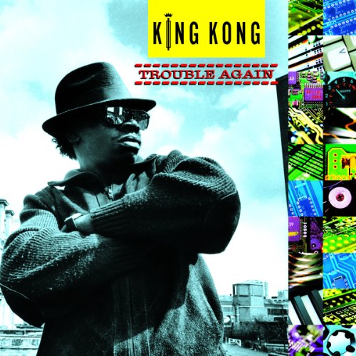 Vinyl album cover with man in hat and sunglasses, against a cityscape.