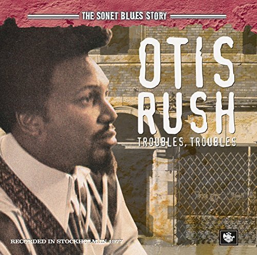 "CD cover featuring Otis Rush with a building and chain-link fence in the background."