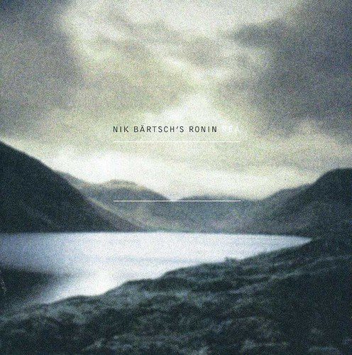 "Album cover with misty lake and mountains, titled 'Nik Bärtsch's Ronin - Rea'."