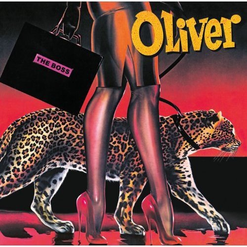 Album cover art featuring a person in shiny red attire with a leopard and briefcase.