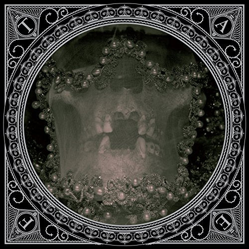 A black-and-white album cover with ornate border and a central, blurry, ghostly image.