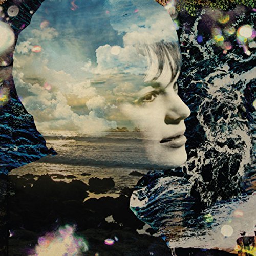 "CD album cover featuring a man's face with a beach scene inside his head."