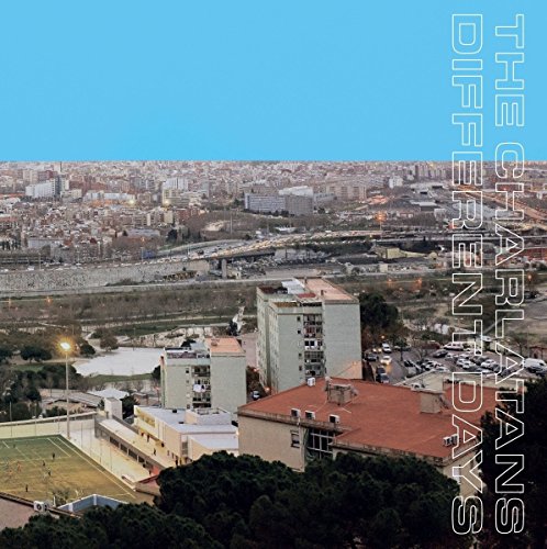 "Album cover with cityscape and blue sky, 'The Charlatans Different Days' written vertically."