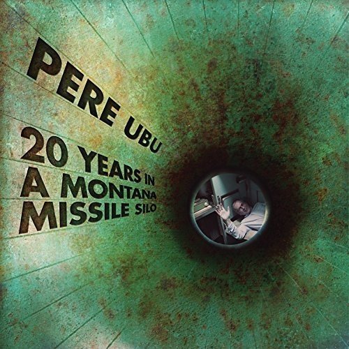 The image is an album cover for "20 Years in Montana" by Pere Ubu. * The title and artist name are prominently displayed on the left side of the image. * The text is in a bold, black font and reads "PERE UBU" on one line, followed by "20 YEARS IN A MONTANA MISSILE SILO" on three lines below. * A circular inset on the right side of the image shows a man holding a camera, looking