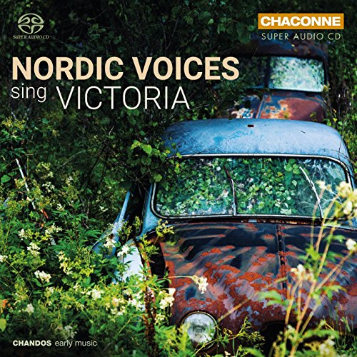"CD cover featuring a rusty, overgrown vintage car surrounded by greenery and white flowers."