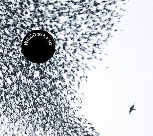 Wilco’s “Sky Blue Sky” CD cover: birds in flight, dark circle, bird.