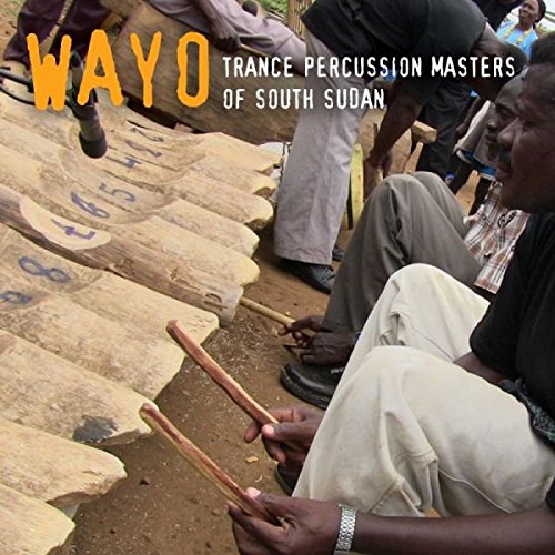 "CD cover showing men playing log drums with sticks, outdoors."