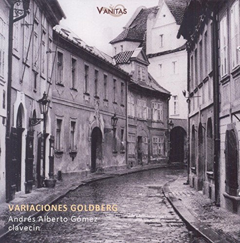A black-and-white cobblestone street scene on a CD cover with red borders.