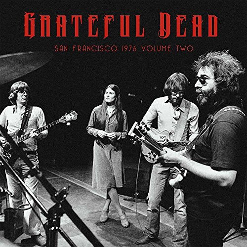 "Black and white image of the Grateful Dead band performing on stage."
