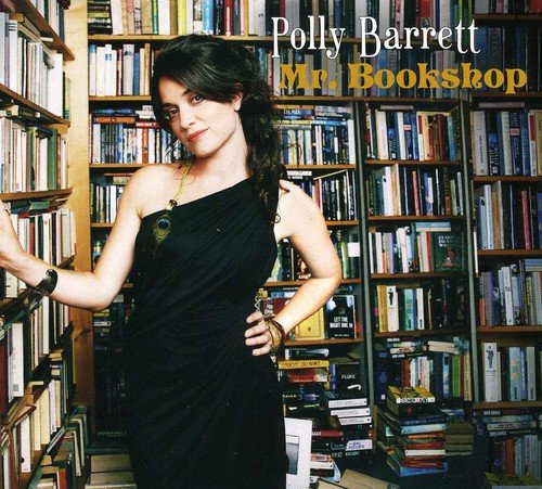 "Album cover: woman in black dress standing in a library with bookshelves."