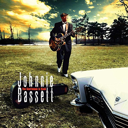 "Album cover featuring a man in a suit holding a guitar near a vintage car."