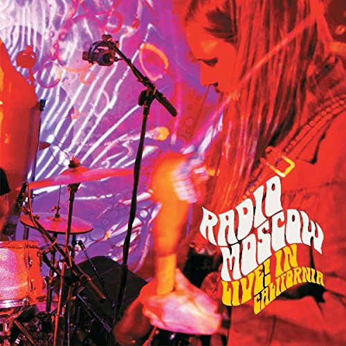 "Album cover featuring a man playing drums under red and purple lighting."