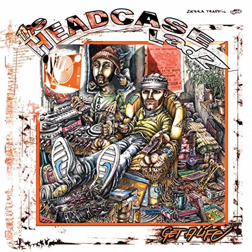 Album cover art featuring two men lounging in a cluttered room, surrounded by various objects.