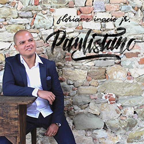 Album cover with a man in a suit leaning on a wooden table.
