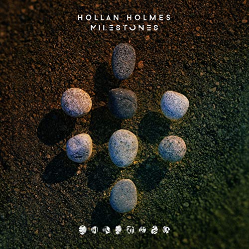 Album cover with nine stones arranged in a triangle on a dirt surface.