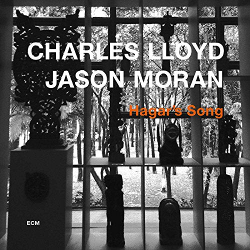 "Album cover with black and white photo, grid window, and statues, titled 'Hagar's Song'."