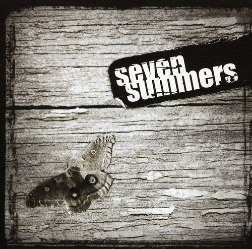 "Album cover with 'seven summers' text and a moth on a wooden background."