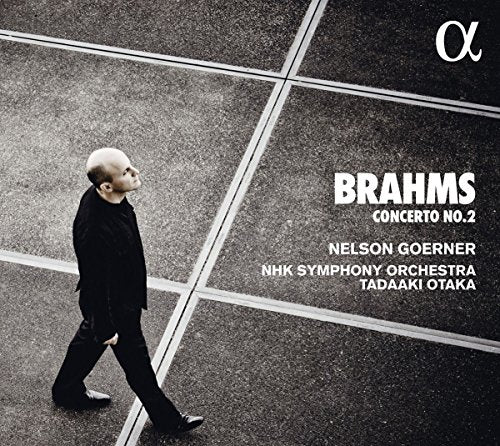 Bald man in black walks on grey pavement with white lines, CD cover art.