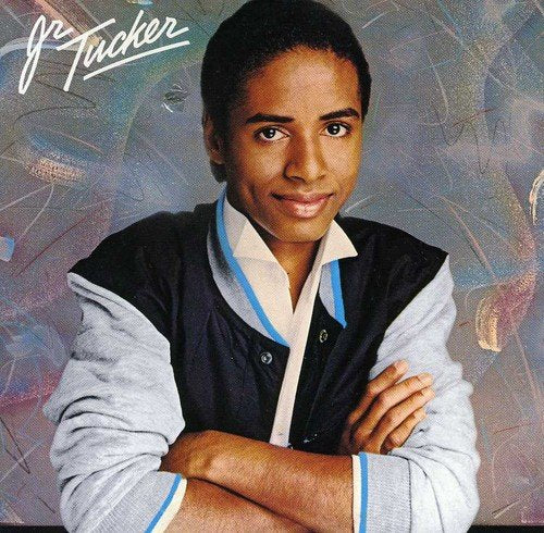 Album cover featuring Junior Tucker with crossed arms, wearing a black and white jacket.