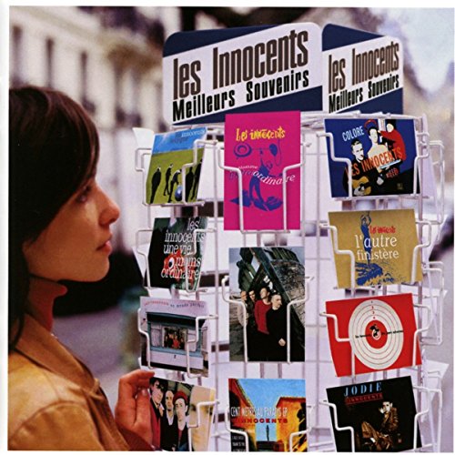 "CD display rack with 'Les Innocents Meilleurs Souvenirs' CDs and various album covers."