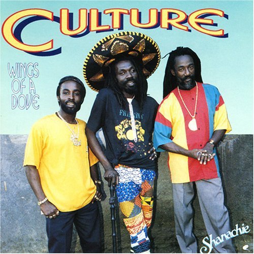 Album cover featuring three men standing together, wearing colorful clothing and gold jewelry.