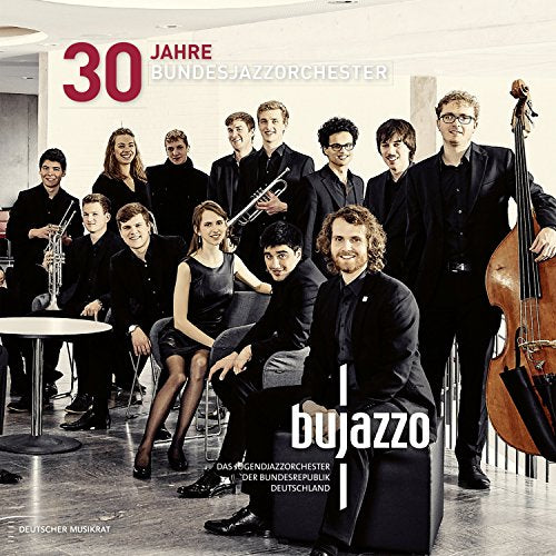 "CD cover featuring a group of 12 musicians in formal attire posing together."