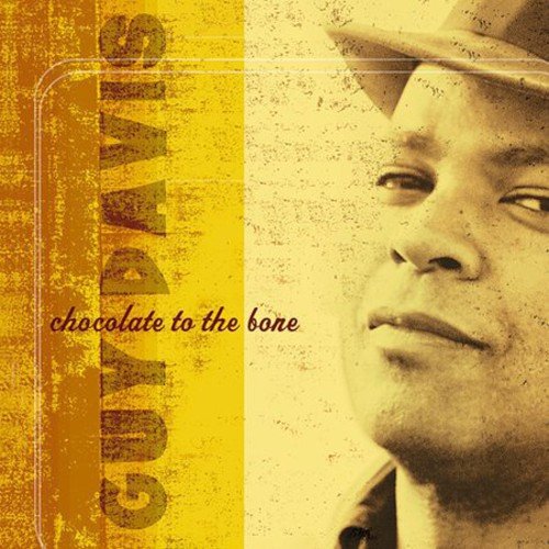 Album cover with a man's face and hat, yellow and brown colors.
