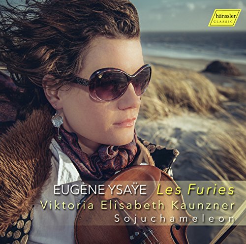 A woman holding a violin on a beach, with text overlay.