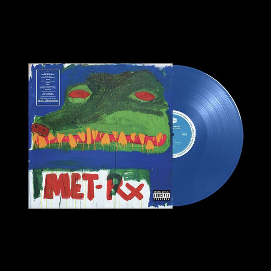 "Vinyl album cover featuring a green crocodile head with red eyes on blue background."