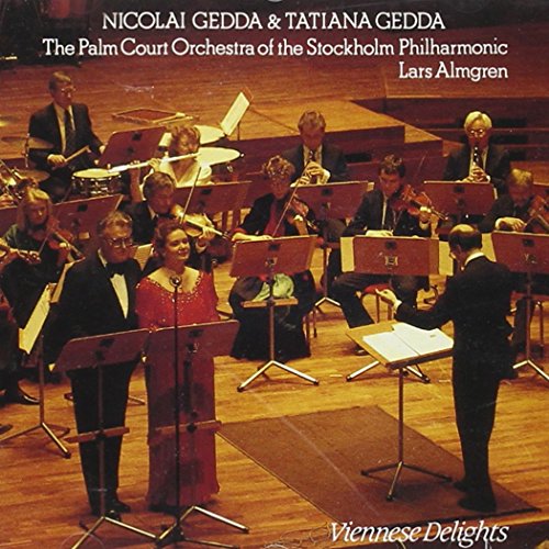 "CD cover featuring a man and woman singing with an orchestra on stage."
