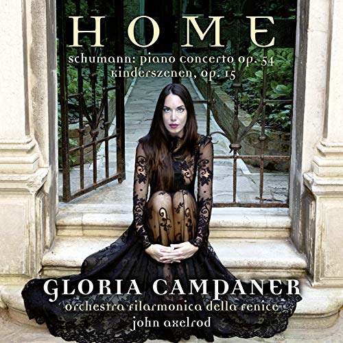 The image depicts a woman sitting on steps, with the text "HOME" and "GLORIA CAMPANER" prominently displayed. Here is a concise description of the image in 15 words or less: Woman in black dress sits on stone steps, with "HOME" and "GLORIA CAMPANER" text overlay.