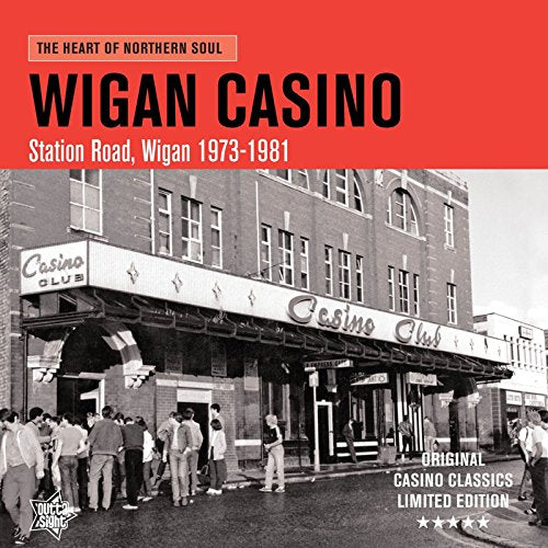 "Album cover with red banner and black-and-white image of Wigan Casino building and crowd."
