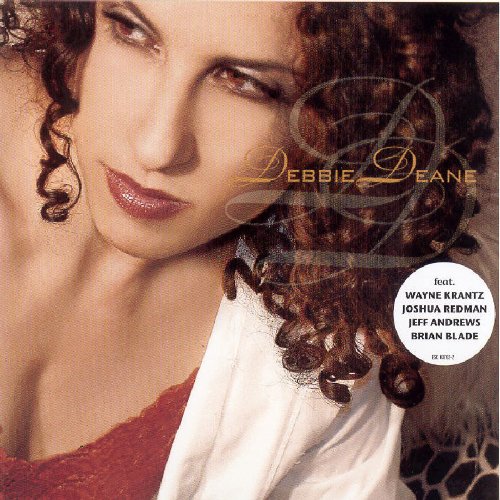 "Album cover featuring a close-up portrait of a woman with curly dark hair."