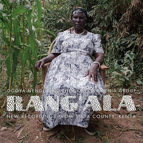 "Album cover featuring a woman sitting in a chair surrounded by greenery."