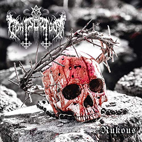 A bloody skull with a crown of thorns on a rocky surface.