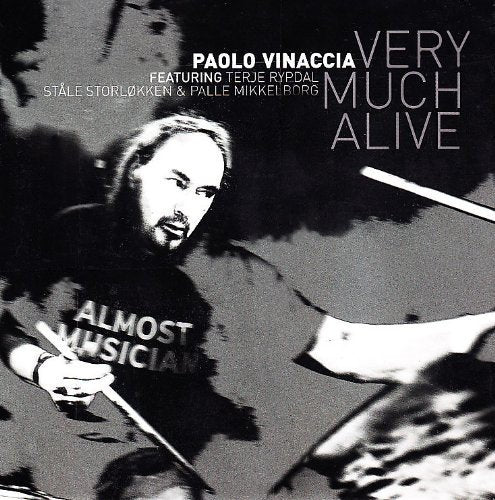 Black and white album cover with man holding drumsticks and "ALMOST MUSICIAN" on shirt.